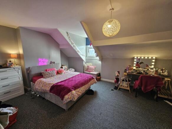 A spacious and cozy master bedroom featuring a ...