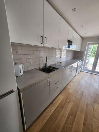 A modern, well-maintained kitchen featuring sle...