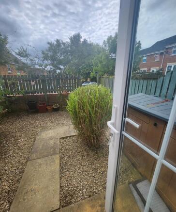 A charming garden space featuring a gravel grou...
