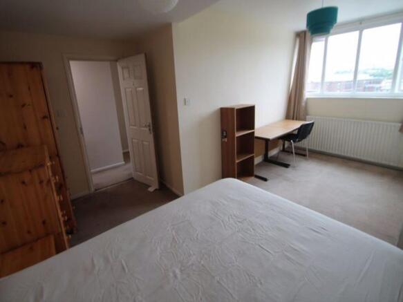 Bright and spacious master bedroom featuring a ...