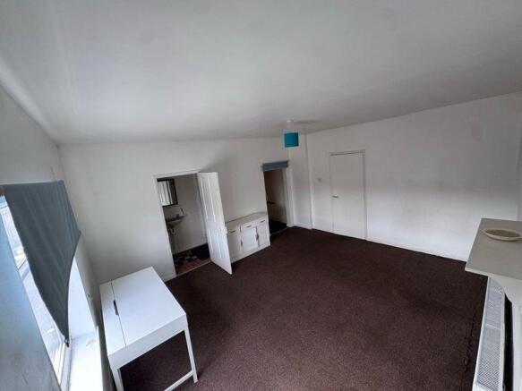 A bright and spacious living room featuring lar...