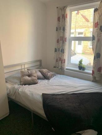 A cozy double bedroom featuring a comfortable b...