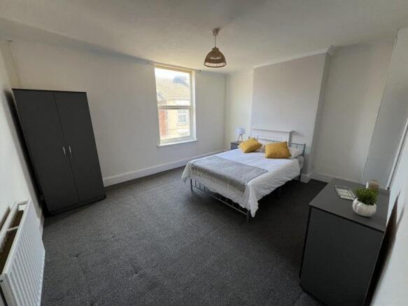 Bright and airy double bedroom featuring a comf...