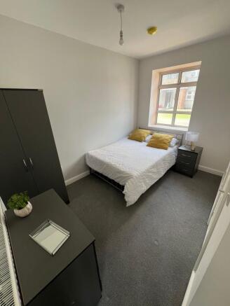 A cozy double bedroom featuring a comfortable b...
