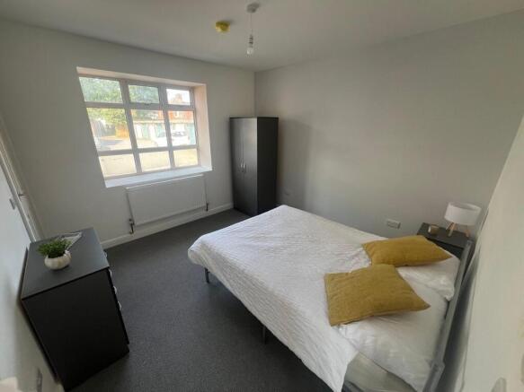 A bright and tidy double bedroom featuring a la...
