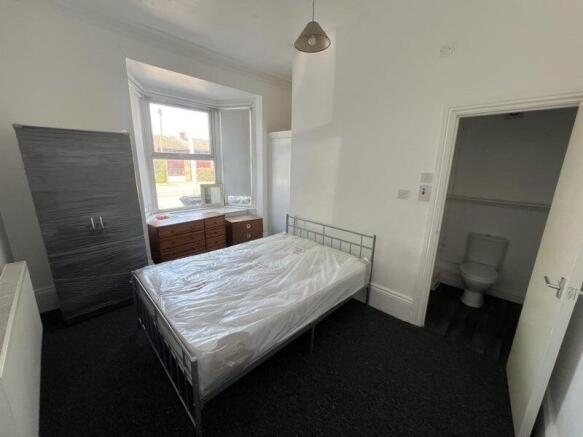 Bright and well-lit master bedroom featuring a ...