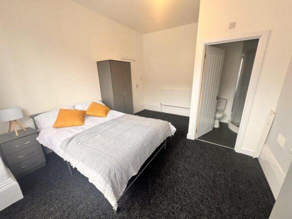 Bright and spacious master bedroom featuring a ...
