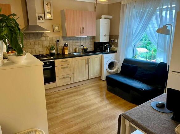 A bright and tidy kitchen featuring modern wood...