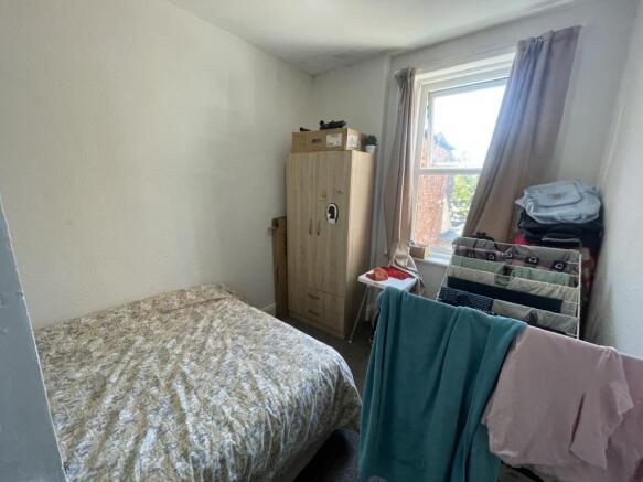 Cozy bedroom with a comfortable single bed, a w...