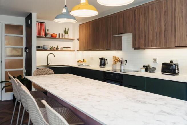 A sleek, modern kitchen featuring a spacious ma...