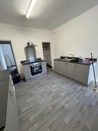A modern kitchen featuring sleek grey cabinets ...