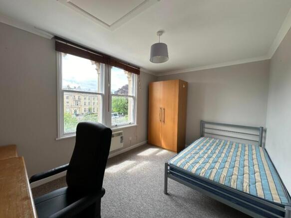 Bright and spacious double bedroom featuring la...