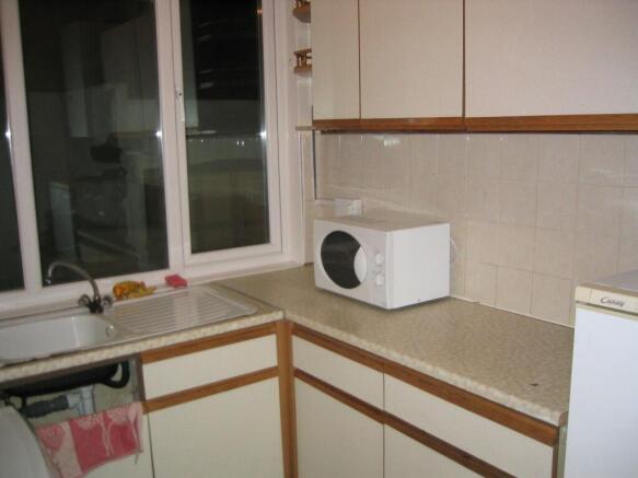 Compact kitchen featuring ample countertop spac...