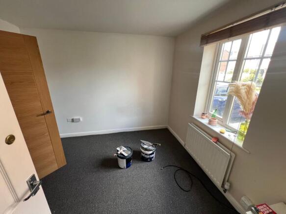 A bright single bedroom with a large window all...