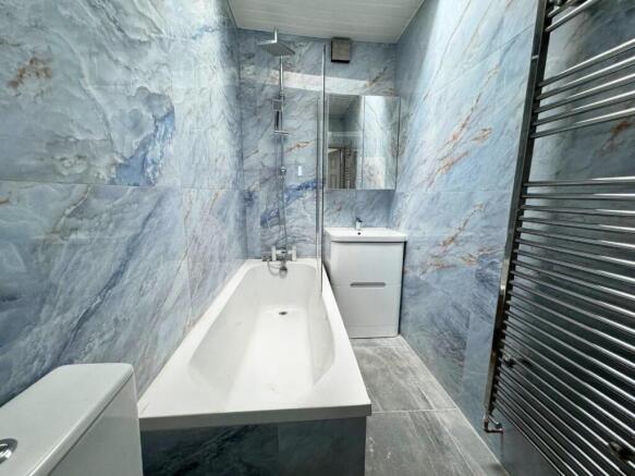 A stylish and modern bathroom featuring elegant...