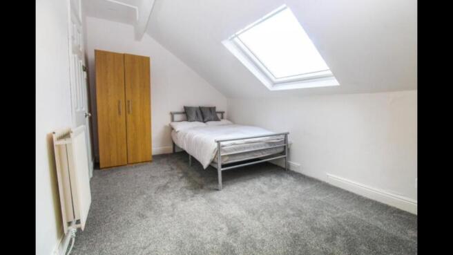 Bright and clean double bedroom featuring a lar...