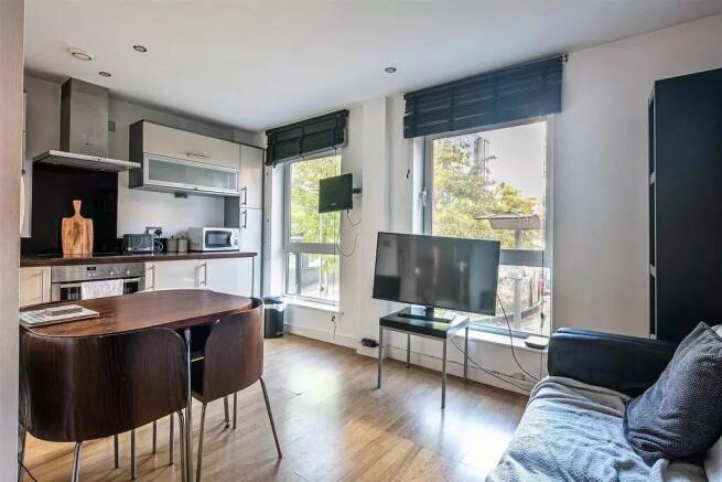 Bright and modern living room featuring large w...