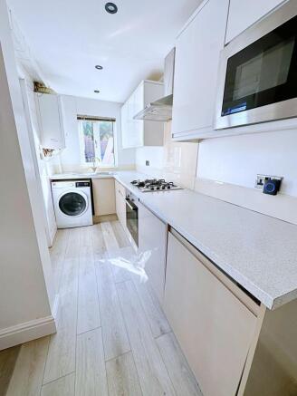 Bright and modern kitchen featuring sleek white...