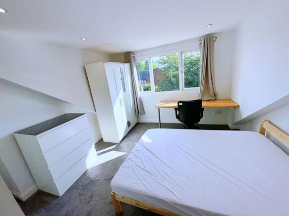 Bright and tidy double bedroom featuring a larg...