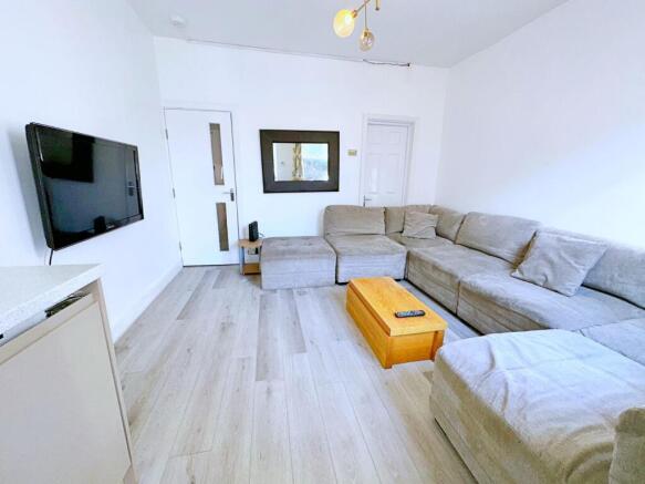 Bright and modern living room featuring a large...