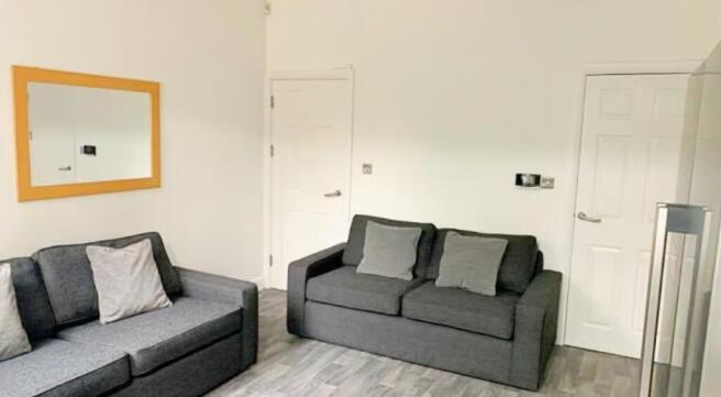 A cozy living room featuring comfortable sofas ...
