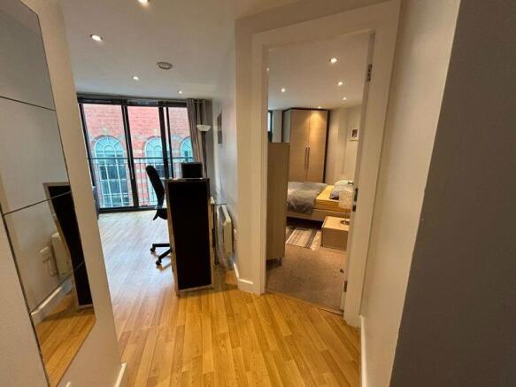 A bright and modern master bedroom with ample n...