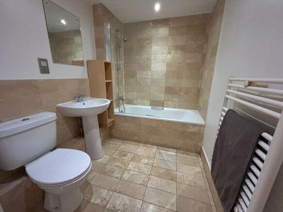 A modern bathroom suite featuring a clean white...