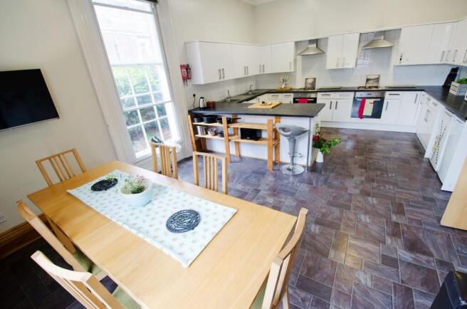 Bright and spacious kitchen featuring modern wh...