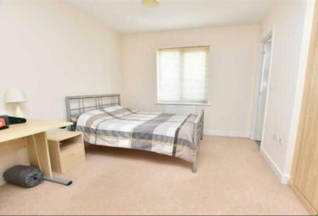 Bright and tidy double bedroom featuring a larg...