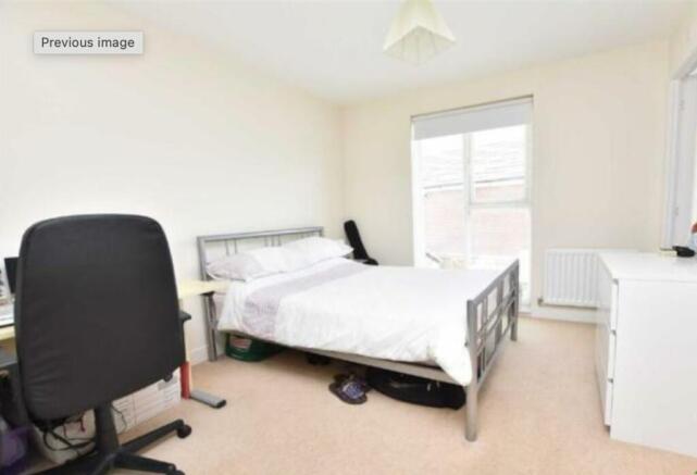 Bright and spacious master bedroom featuring a ...