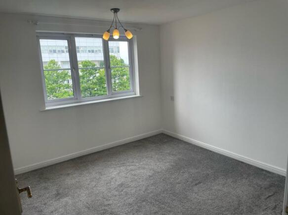Bright and spacious master bedroom featuring a ...
