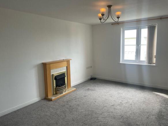 Bright and airy living room featuring a large w...
