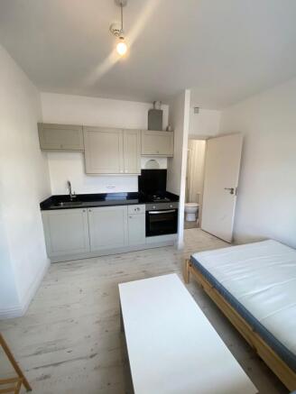 Bright and tidy studio room featuring a compact...