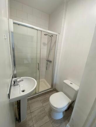 A clean and modern bathroom featuring a glass-e...