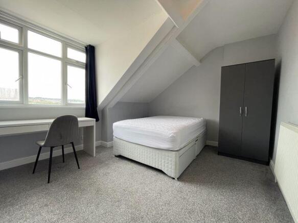 Bright and tidy double bedroom featuring a comf...