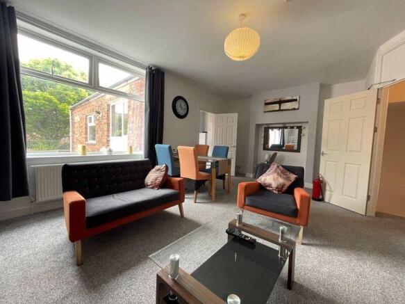 A bright and inviting living room featuring com...