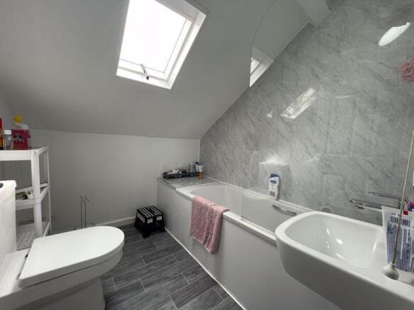 Bright and modern bathroom featuring a spacious...