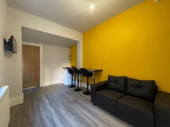 A modern living room featuring a vibrant yellow...