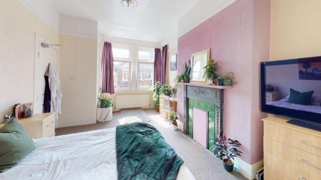 A bright and inviting master bedroom featuring ...