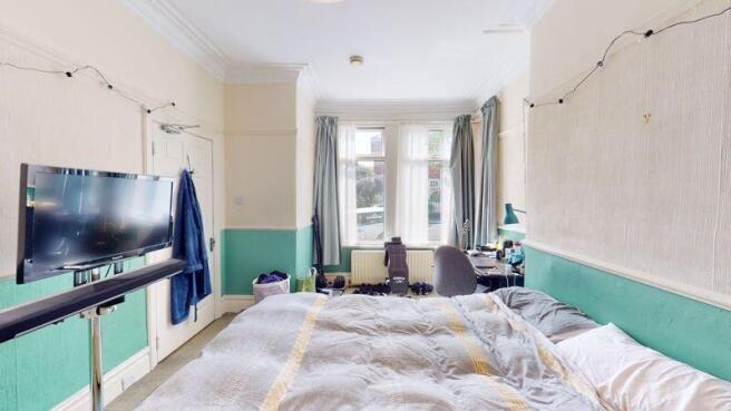A spacious and bright master bedroom featuring ...