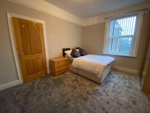 A cozy double bedroom featuring a comfortable d...