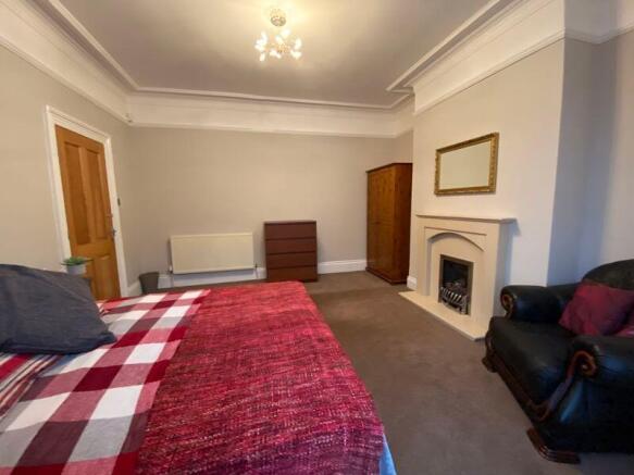 A spacious and inviting master bedroom featurin...