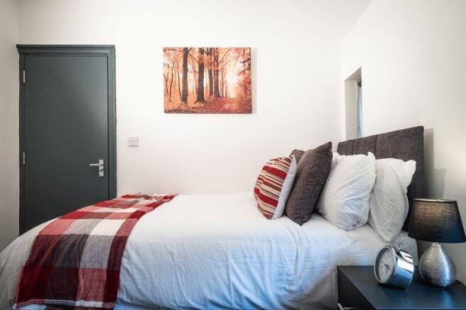 Bright and cozy double bedroom featuring a comf...