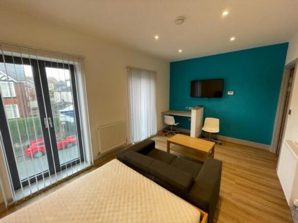 Bright and spacious master bedroom featuring a ...