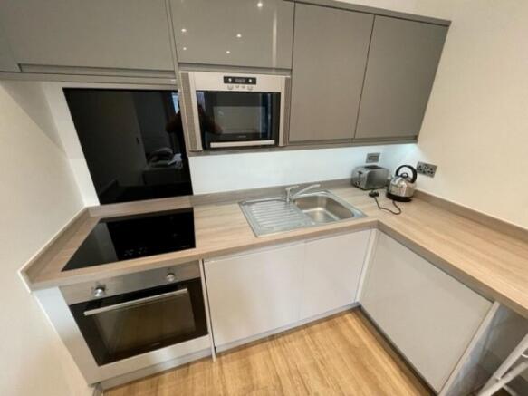 Modern kitchen with sleek cabinetry, integrated...