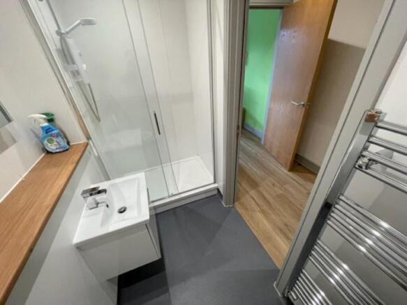 A modern bathroom featuring a glass shower encl...