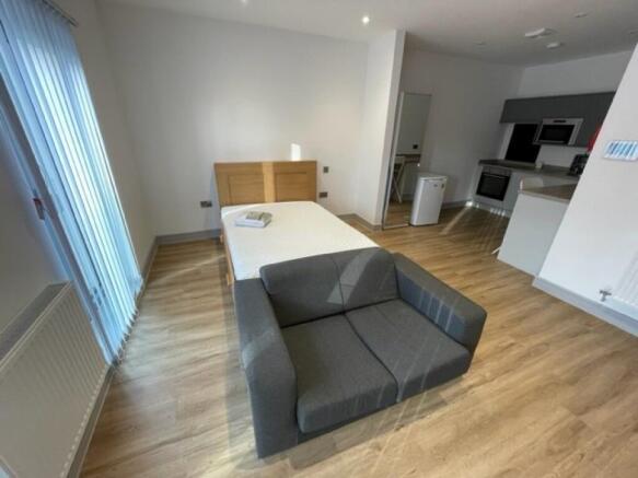 Bright and modern single bedroom featuring a co...