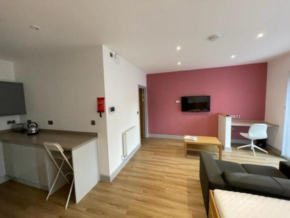 A modern living room with a stylish pink accent...