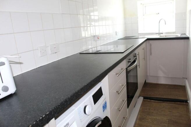 Bright and modern kitchen featuring a clean, sp...