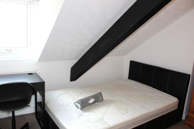 A bright and cozy double bedroom featuring a co...